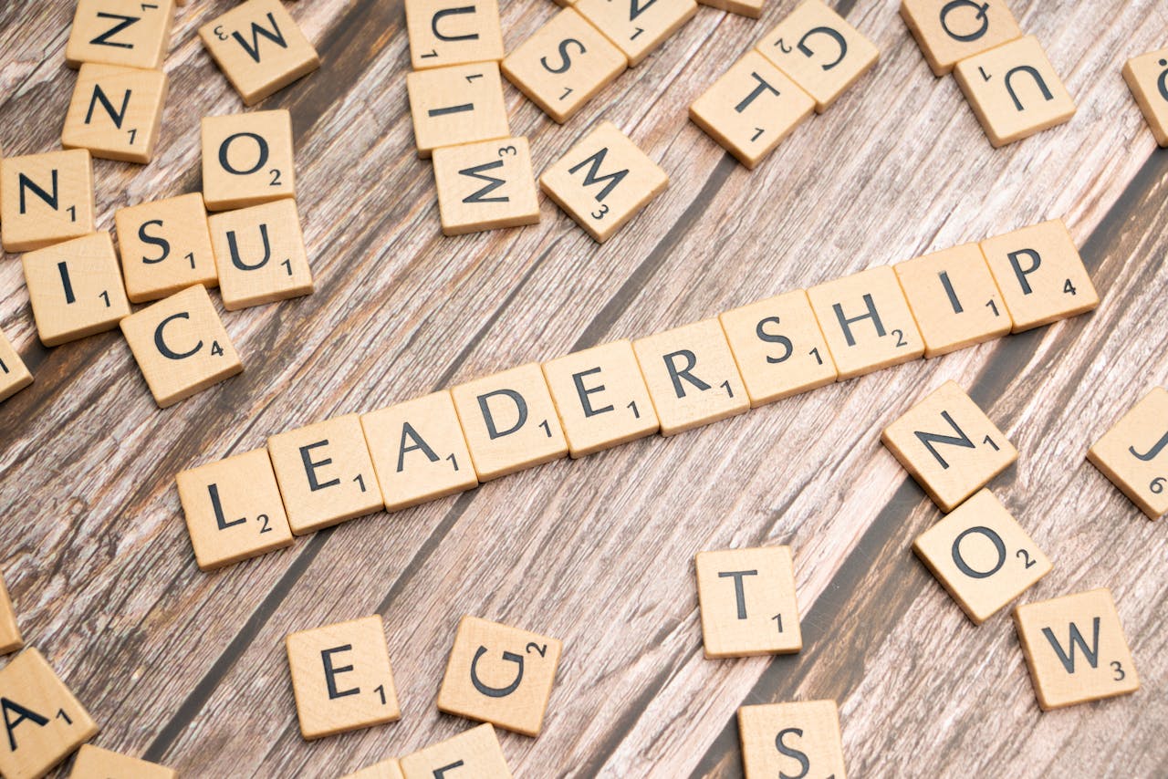 Home Wooden letter tiles spelling 'LEADERSHIP' on a wooden surface, symbolizing leadership qualities and skills.